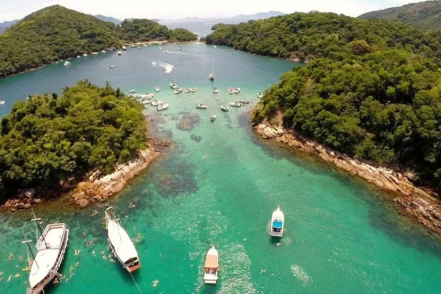 Vista aerea di Ilha Grande, con barche ancorate in acque turchesi tra baie ricoperte di foresta atlantica.