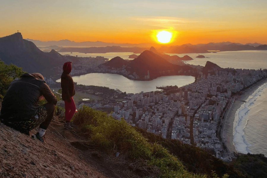 Sunset seen from the top of Morro Dois Irmãos, offering panoramic views of Vidigal, Rio de Janeiro’s beaches and Christ the Redeemer in the background.