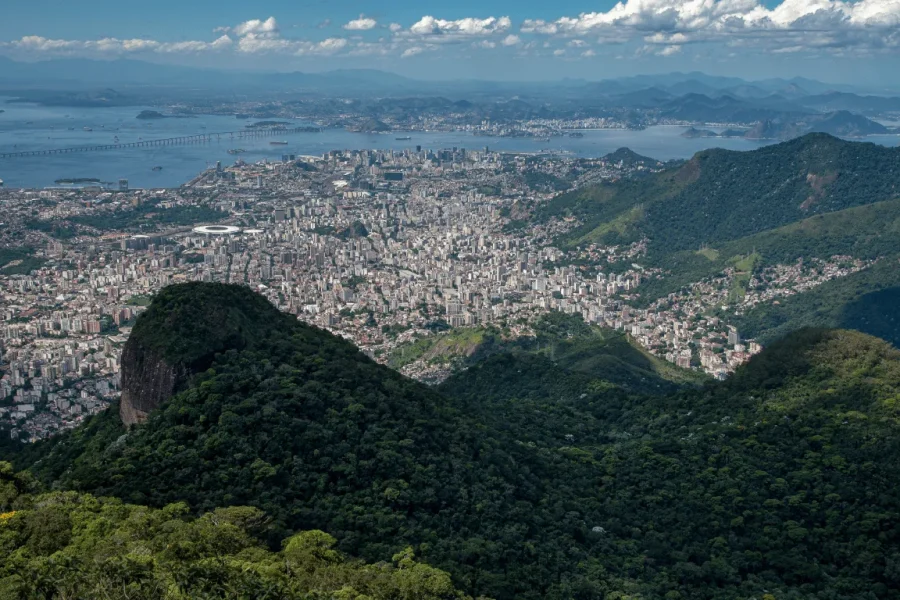 Panoramic view from Pico da Tijuca over the city of Rio de Janeiro, with the Tijuca Forest in the foreground, Guanabara Bay, the Rio-Niterói Bridge and Sugarloaf Mountain in the background, Rio de Janeiro, Brazil.