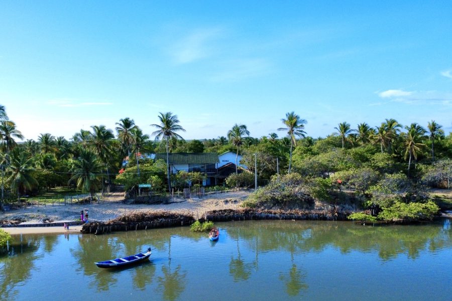 River view of Bar da Hora near Casa Ingapura with canoe and palm trees