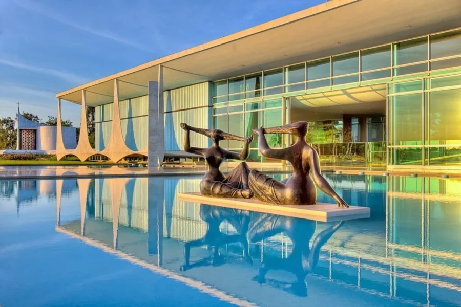 Palácio da Alvorada in Brasília, with a bronze sculpture in the reflecting pool and the curved columns of the façade